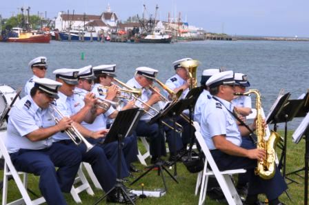 Band plays with harbor in background