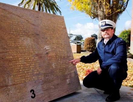 Auxiliarist points out name of his father on memoral